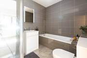 The en-suite bathroom for bedroom 1 has a shower and separate bath.