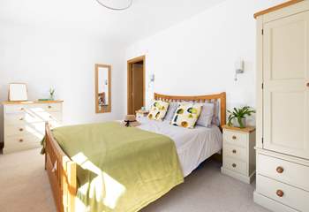 This bedroom is light and airy. 