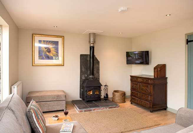 The wood-burner is perfect for cosy film nights snuggled up on the corner sofa.