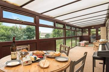 The large conservatory is a lovely space to enjoy holiday meals...
