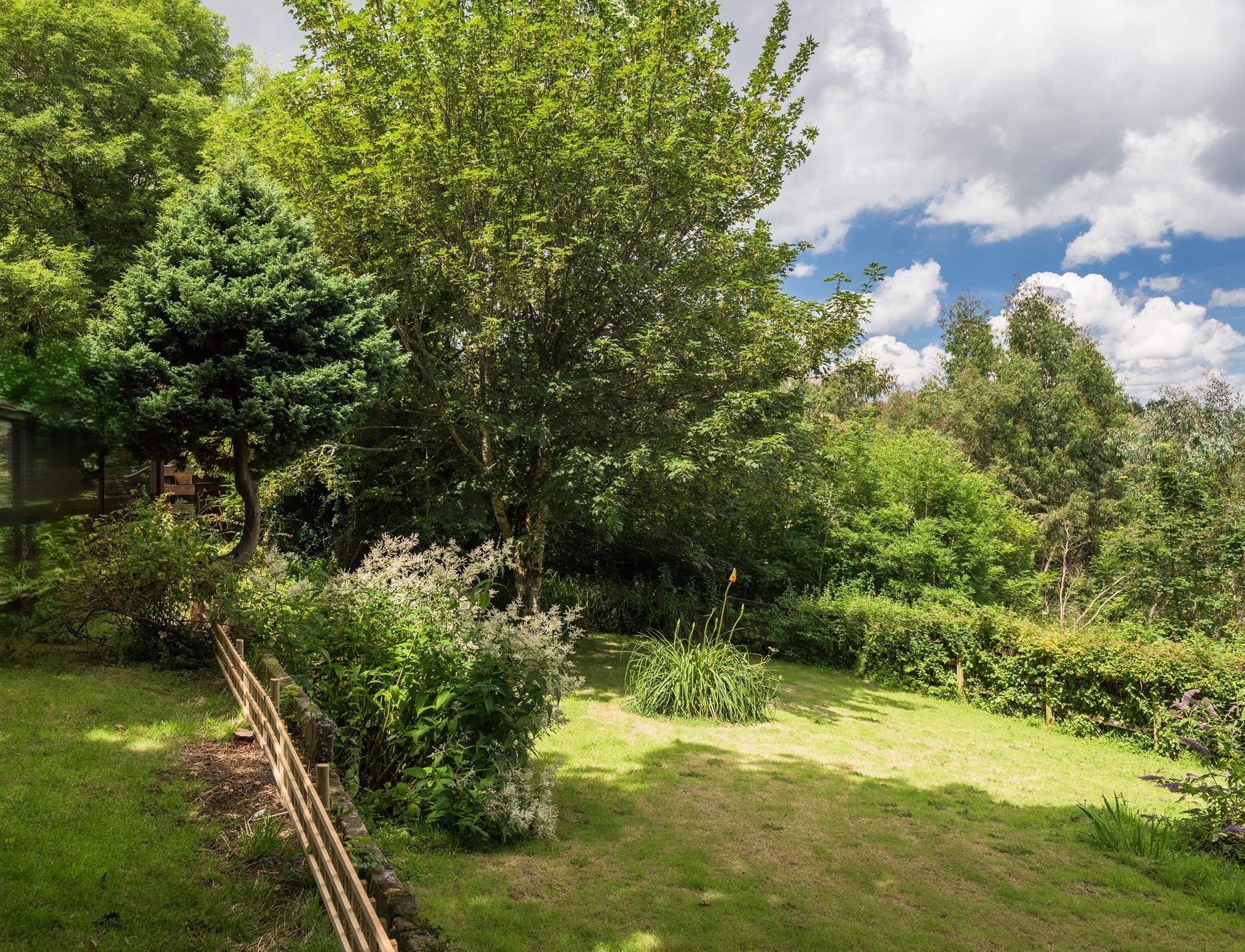 The Garden Room looks out over the garden, which is on two levels with steps from the top area down to the big lawn