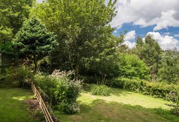 The Garden Room looks out over the garden, which is on two levels with steps from the top area down to the big lawn