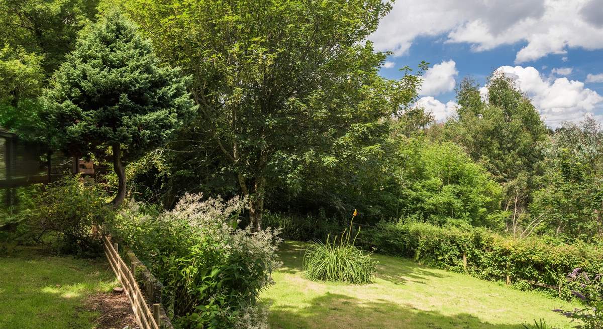 The Garden Room looks out over the garden, which is on two levels with steps from the top area down to the big lawn