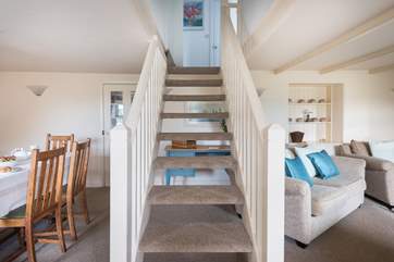 Open-tread stairs up to the first floor.