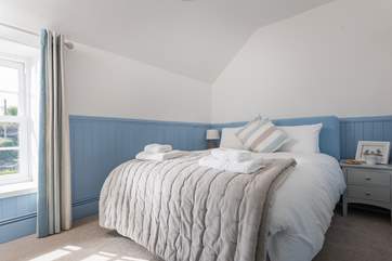 Bedroom 2 is furnished with a king-size bed and is between the bathroom and shower-room, there is a wardrobe in this room.