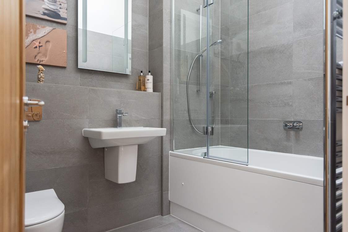 The gorgeous bathroom is located between the two bedrooms.