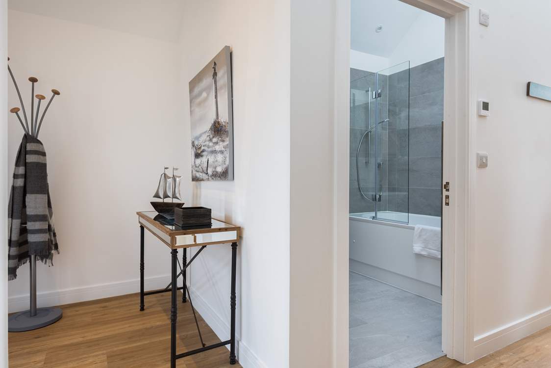 The entrance hall with the bathroom next on the left and a bedroom behind you.