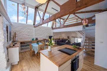The kitchen island looking to the living area (the galleried bedroom is at the far right of the picture).
