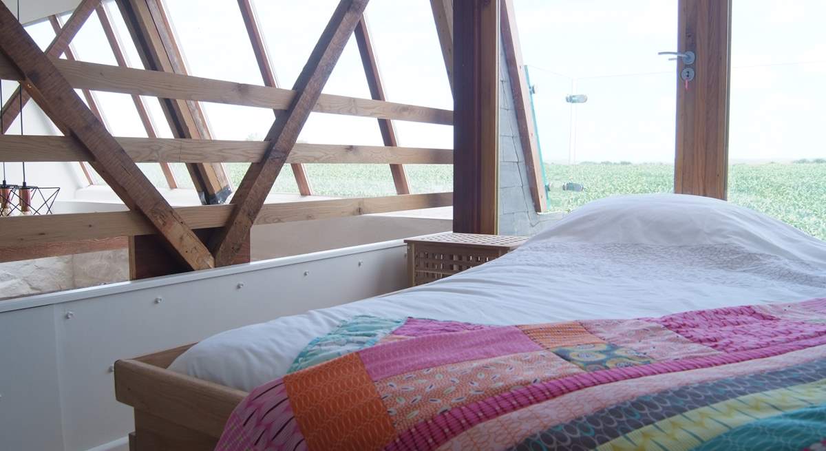 The galleried bedroom on the first floor has a 4' single bed and spectacular countryside views.