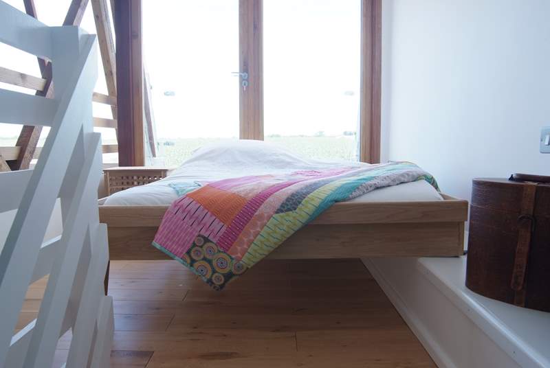 The galleried bedroom has a bespoke bed which can be put away.