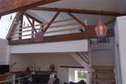 There are open tread stairs up to the galleried bedroom.  This overlooks the ground floor living-area.