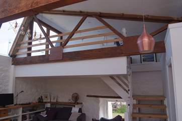 There are open tread stairs up to the galleried bedroom. This overlooks the ground floor living-area.