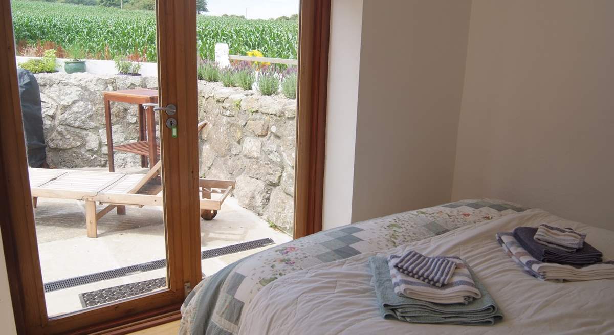 The ground floor double bedroom has doors to the terrace.