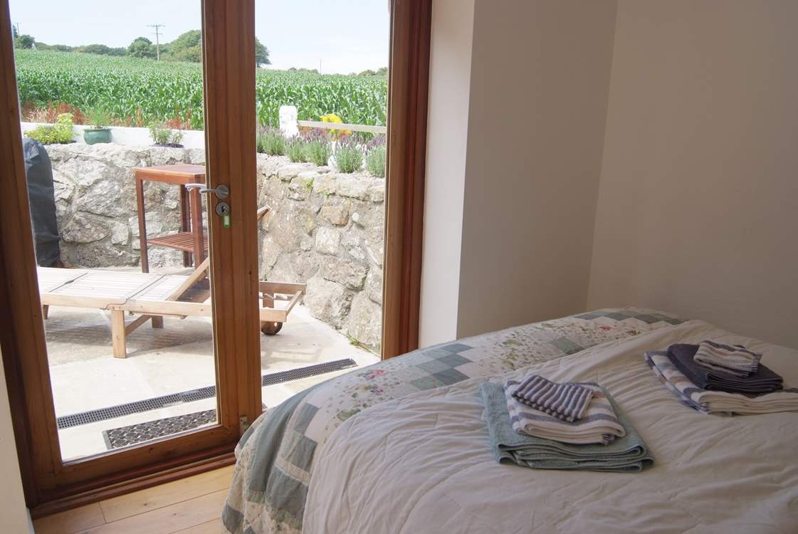 The ground floor double bedroom has doors to the terrace.