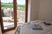 The ground floor double bedroom has doors to the terrace.