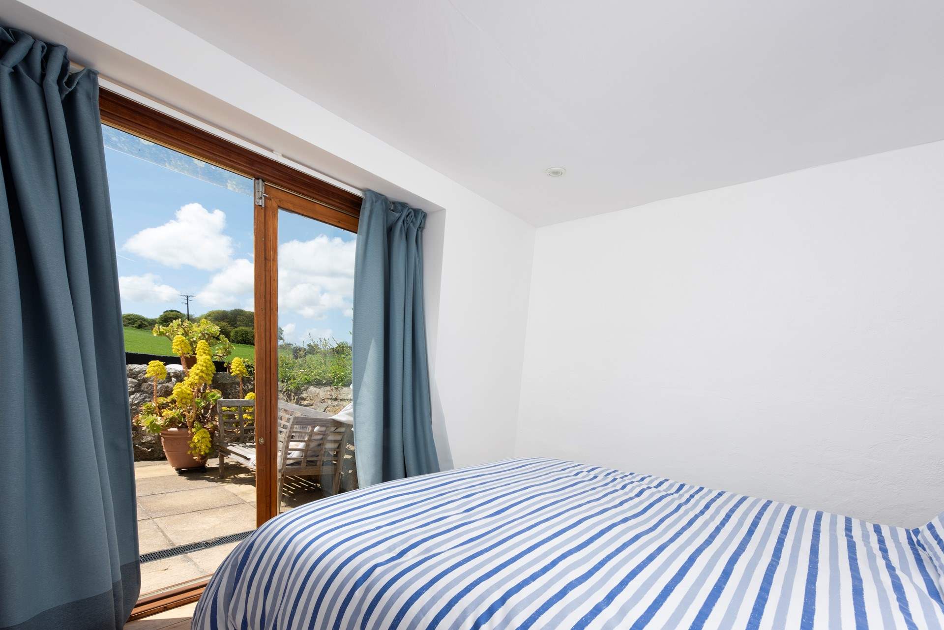 The ground floor bedroom has doors to the terrace.