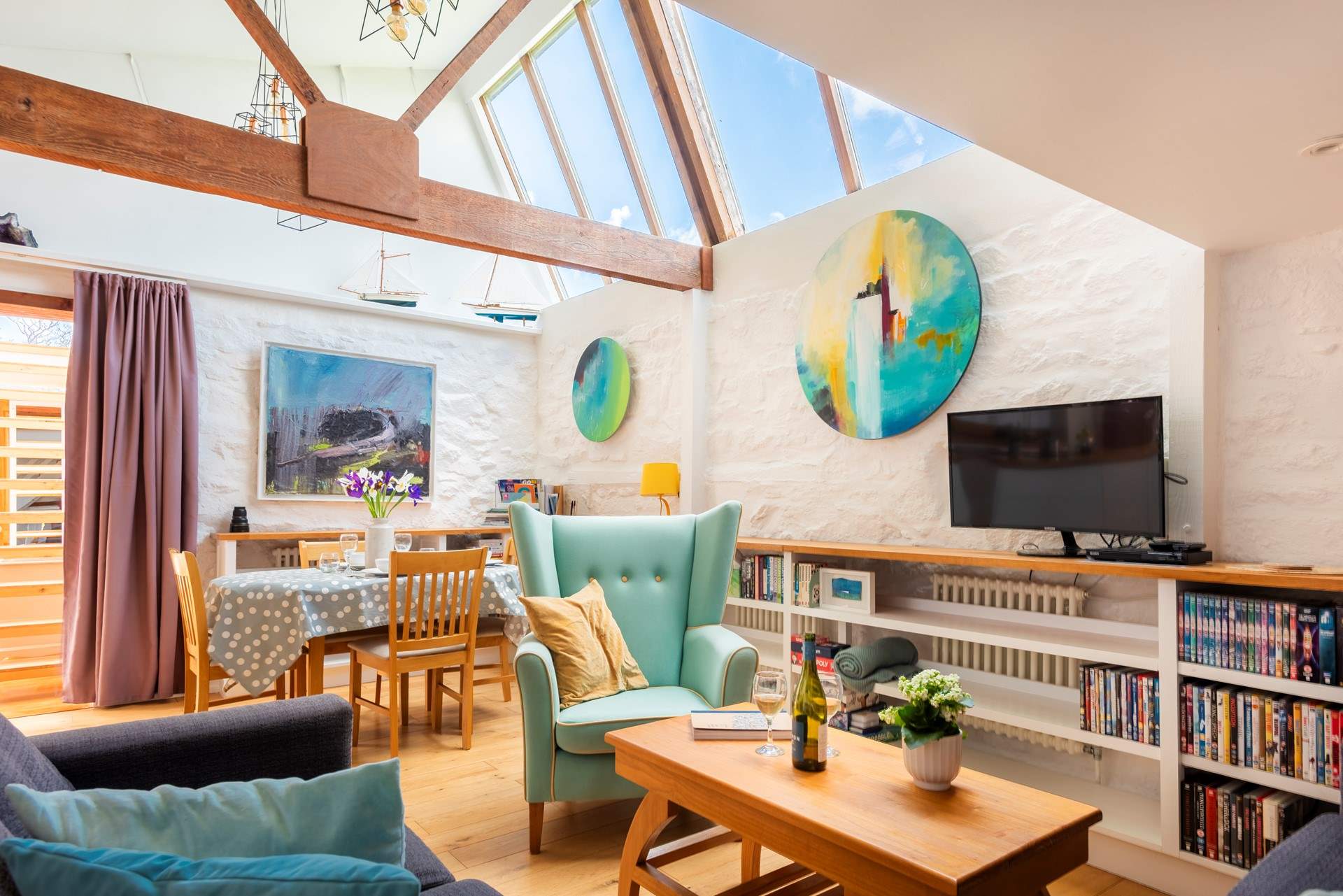 The open plan area with comfy sofas and a dining-table.