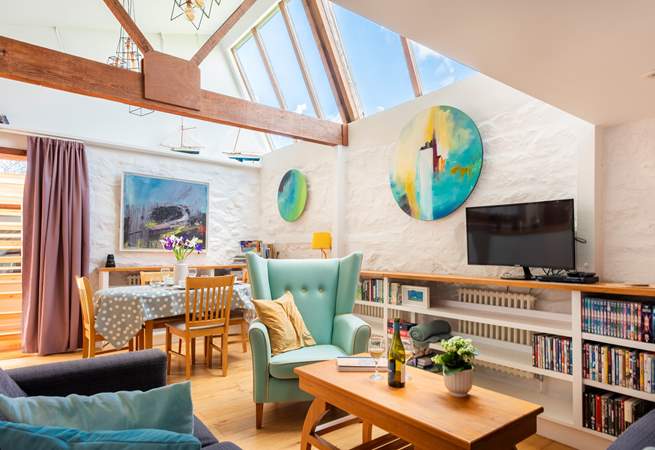The open plan area with comfy sofas and a dining-table.