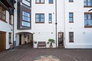 1 Pump Street Mews is accessed by the door to the right of the bench.