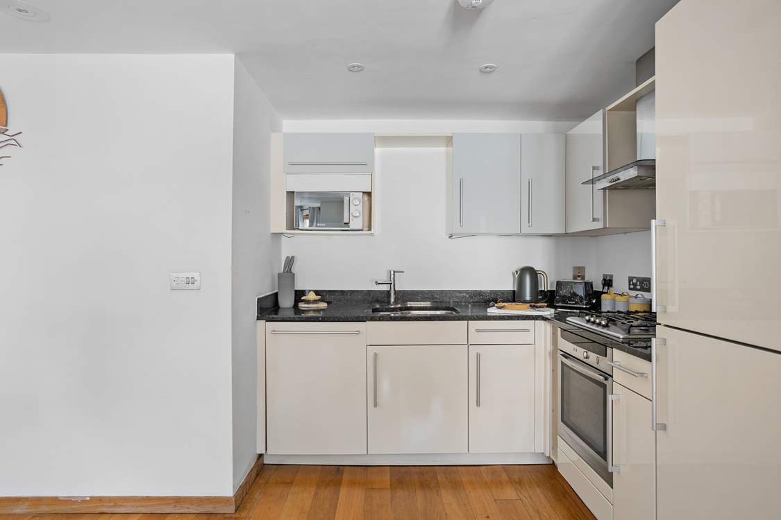 The kitchen is neatly tucked away, yet positioned perfectly so that chef is still part of the group when whipping up a feast.