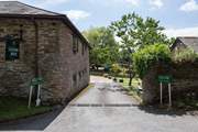 As you enter Stancombe Manor, the car parking area is directly in front of you, with Foxglove 25 yards to the left.