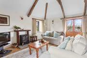 The gorgeous living area has characterful beams and super comfy sofas.