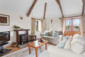 The gorgeous living area has characterful beams and super comfy sofas.