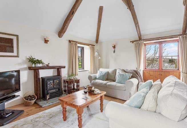 The gorgeous living area has characterful beams and super comfy sofas.