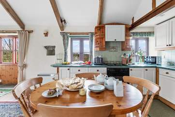 Gather everyone around the farmhouse kitchen table to chat about the day ahead.