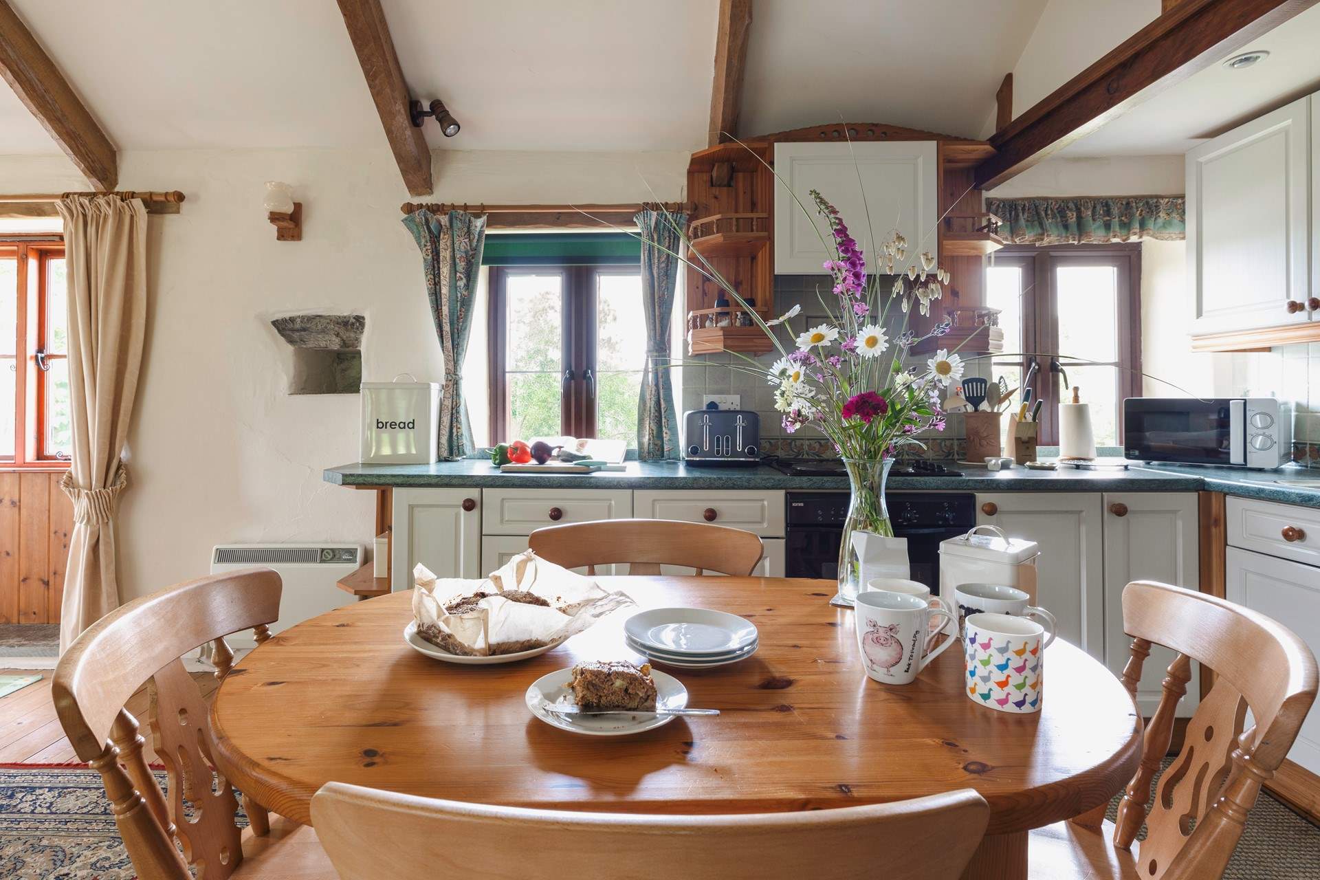 Gather everyone around the farmhouse kitchen table to chat about the day ahead.