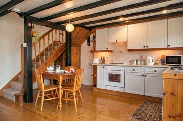 The stairs lead up from the kitchen dining-area.