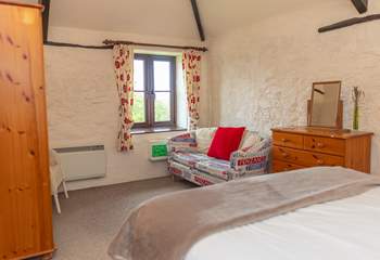 The bedroom retains lovely features and has a view down across the farm and fields.