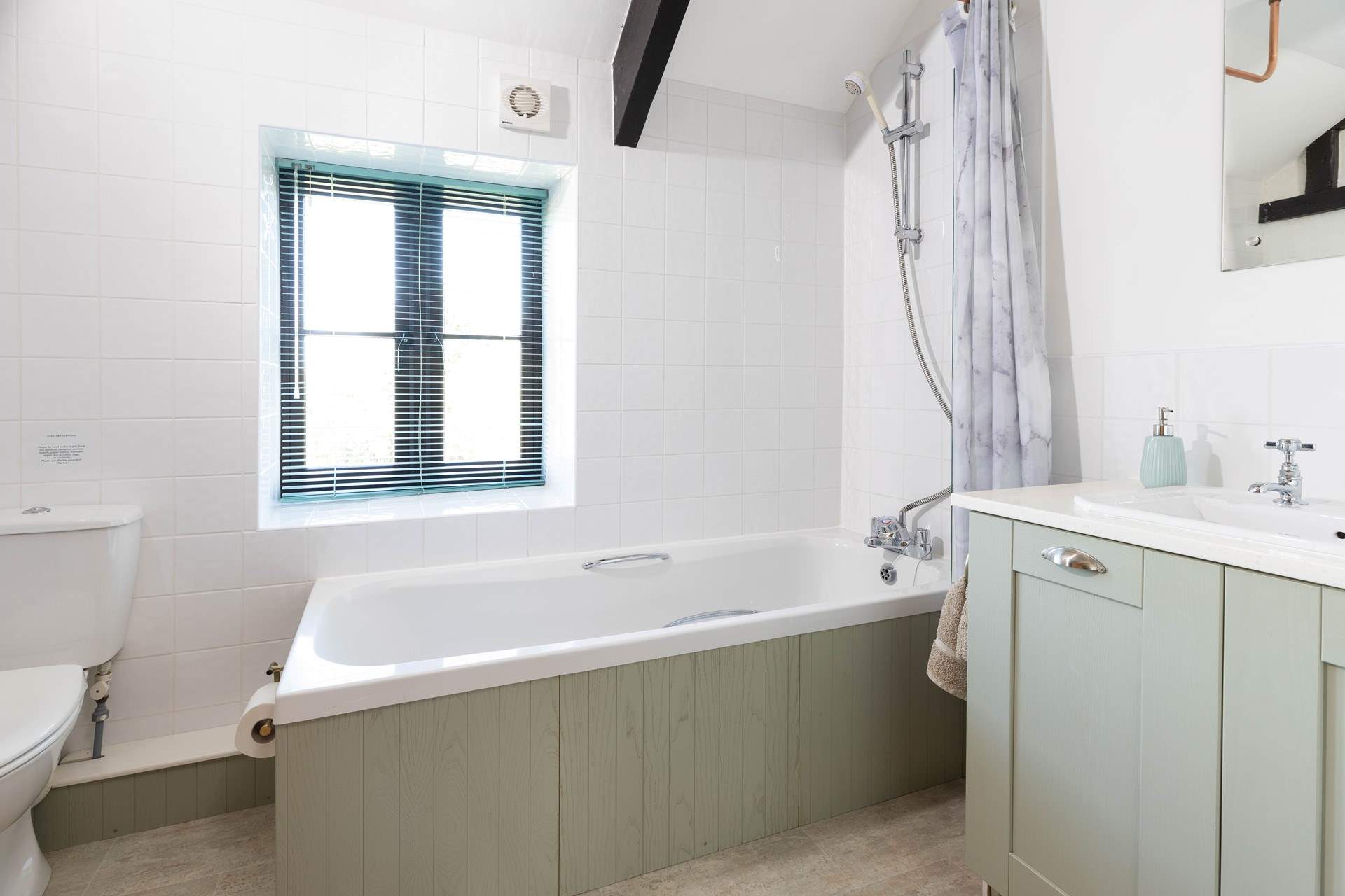 The bathroom is spacious and light and bright. 