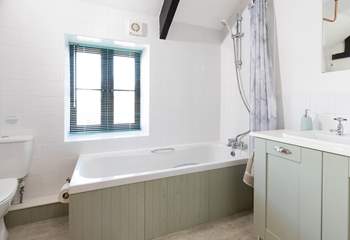 The bathroom is spacious and light and bright. 