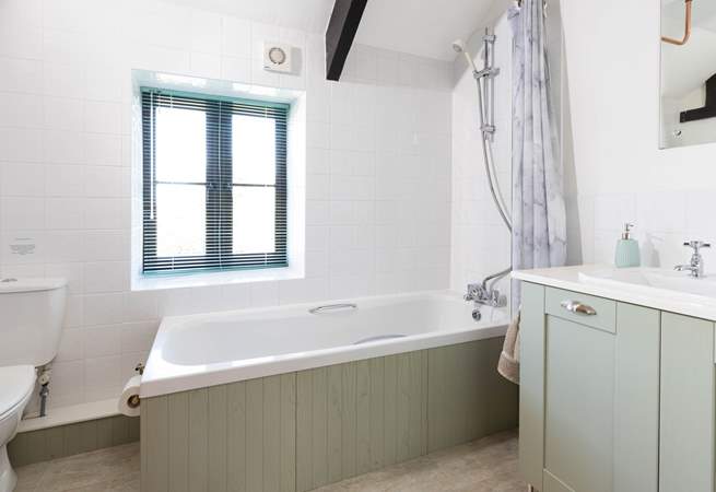 The bathroom is spacious and light and bright. 