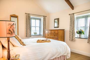 The bedroom is beautifully funished and has a larger than average king-size bed.