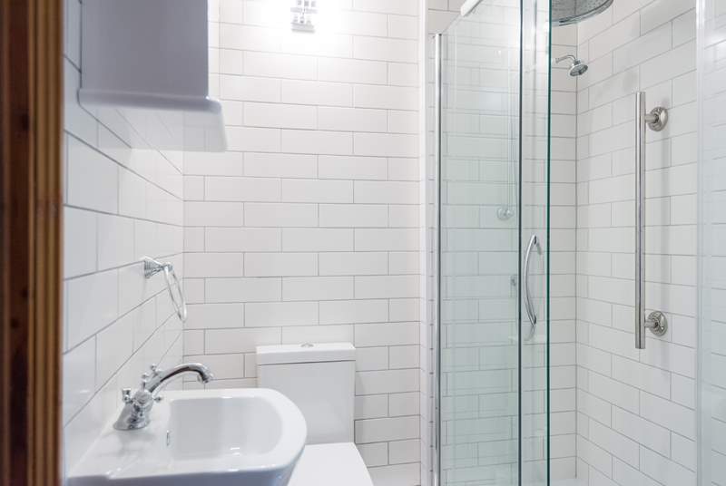 A large shower cubicle with a rainfall shower head.