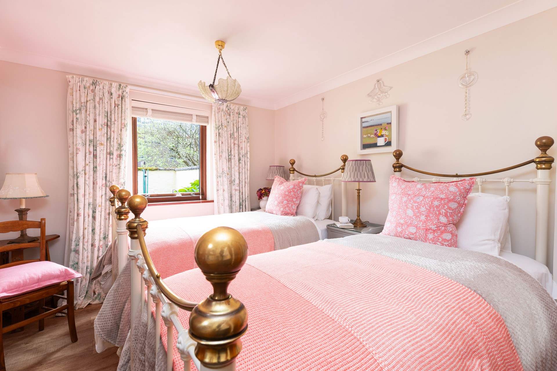 The sweet twin bedroom on the ground is decorated in warming hues. 