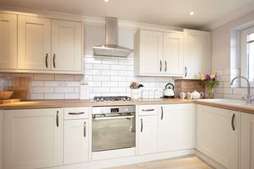 The New England-style kitchen comes well-equipped.