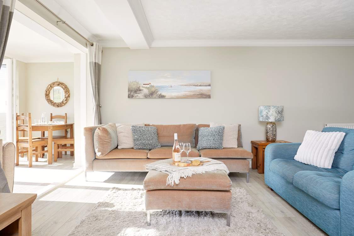 Elegant seating and dining areas enjoy a serene blend of coastal tones and cosy comfort.
