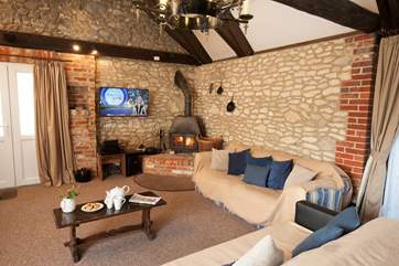 The open plan living-space is great for entertaining. Or snuggle up on the sofa in front of the log-burner.