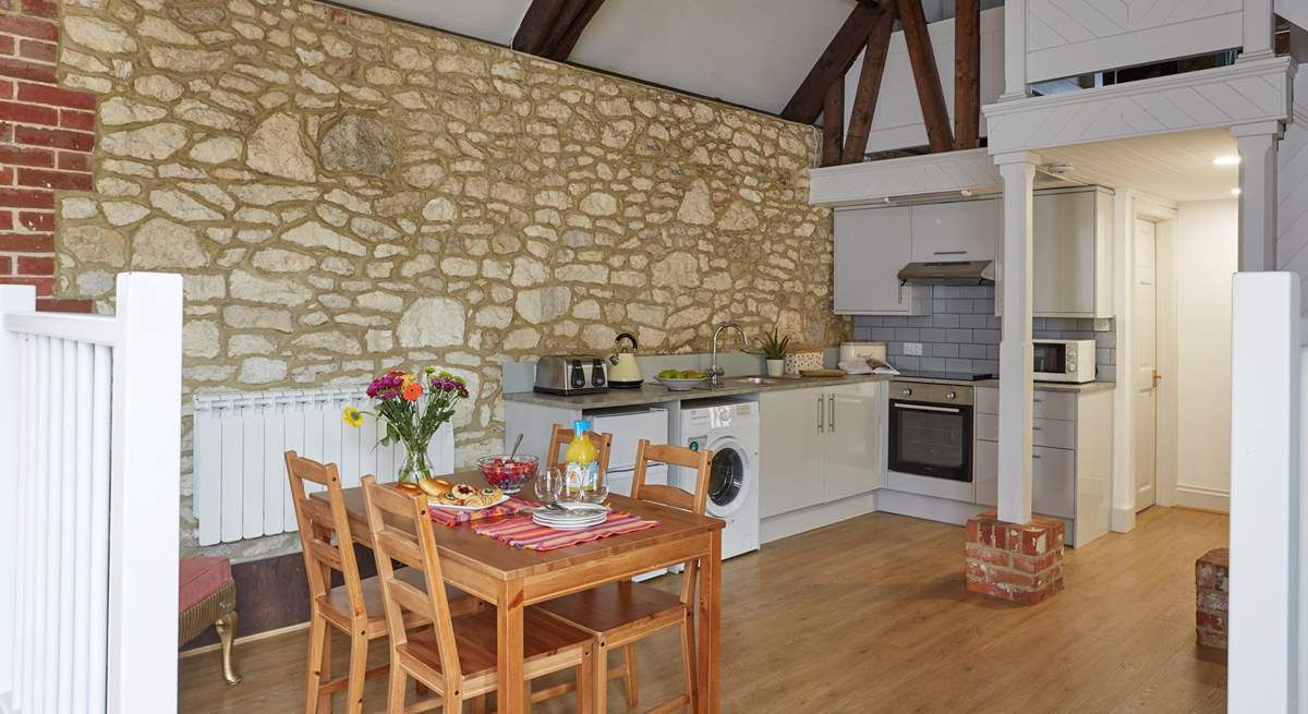 The open plan kitchen and dining-area has a modern fitted kitchen.