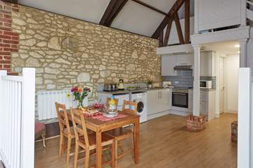 The open plan kitchen and dining-area has a modern fitted kitchen.