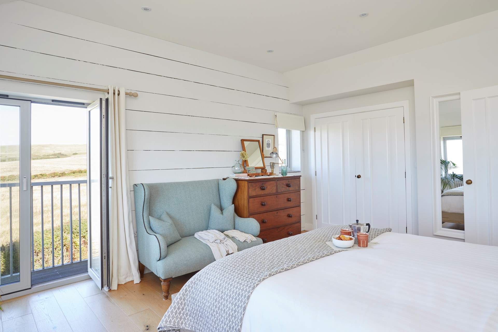 Why not have breakfast in bed and open the balcony doors to let in the morning breeze.