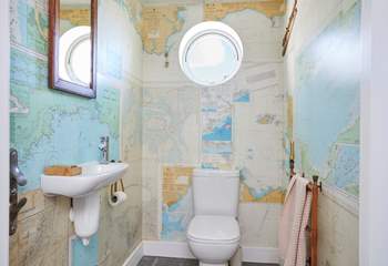 The ground floor cloakroom has rather quirky wallpaper.