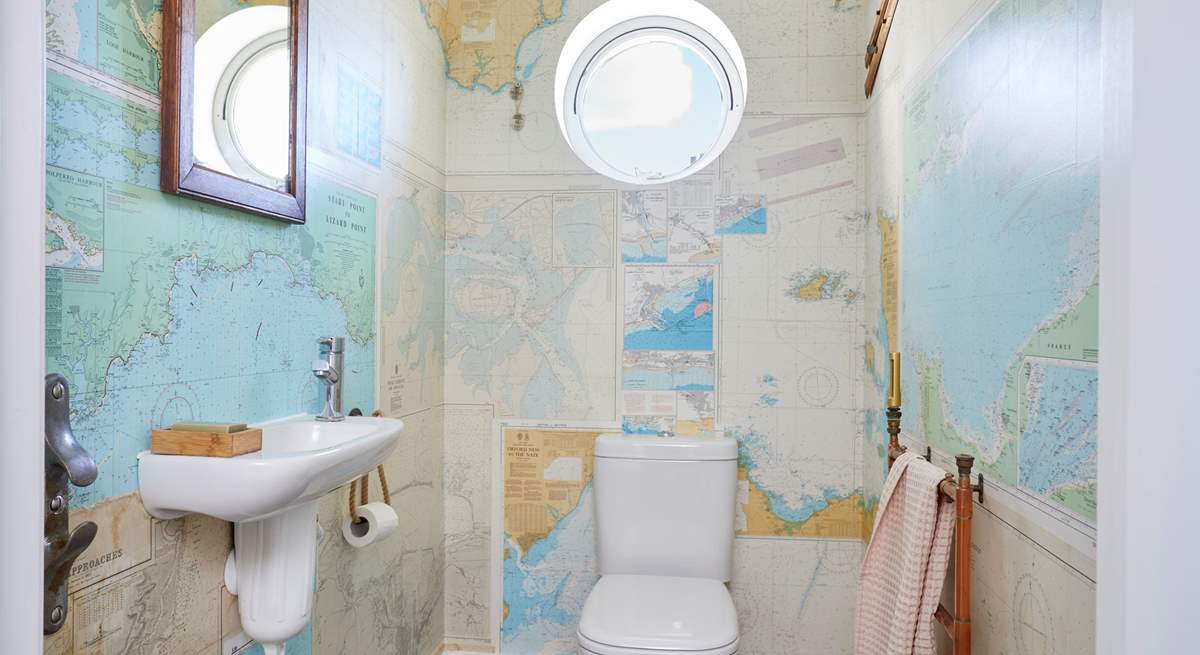 The ground floor cloakroom has rather quirky wallpaper.