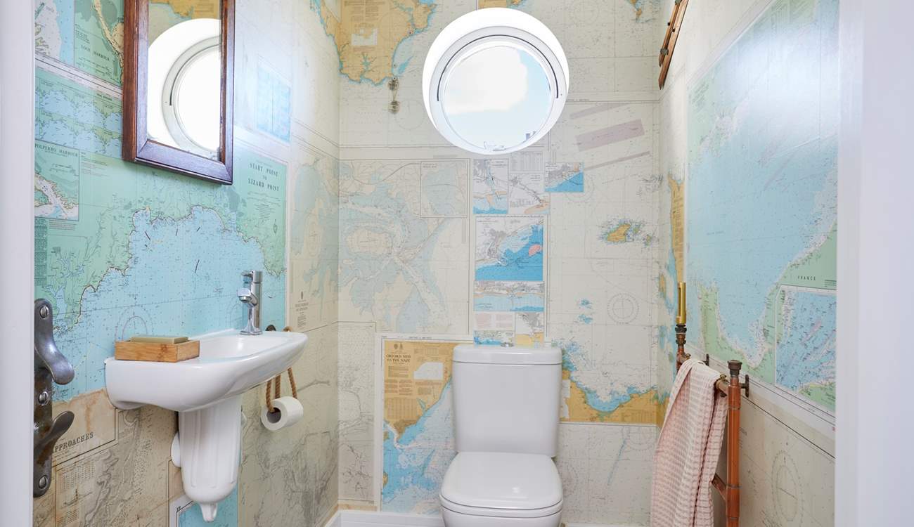 The ground floor cloakroom has rather quirky wallpaper.