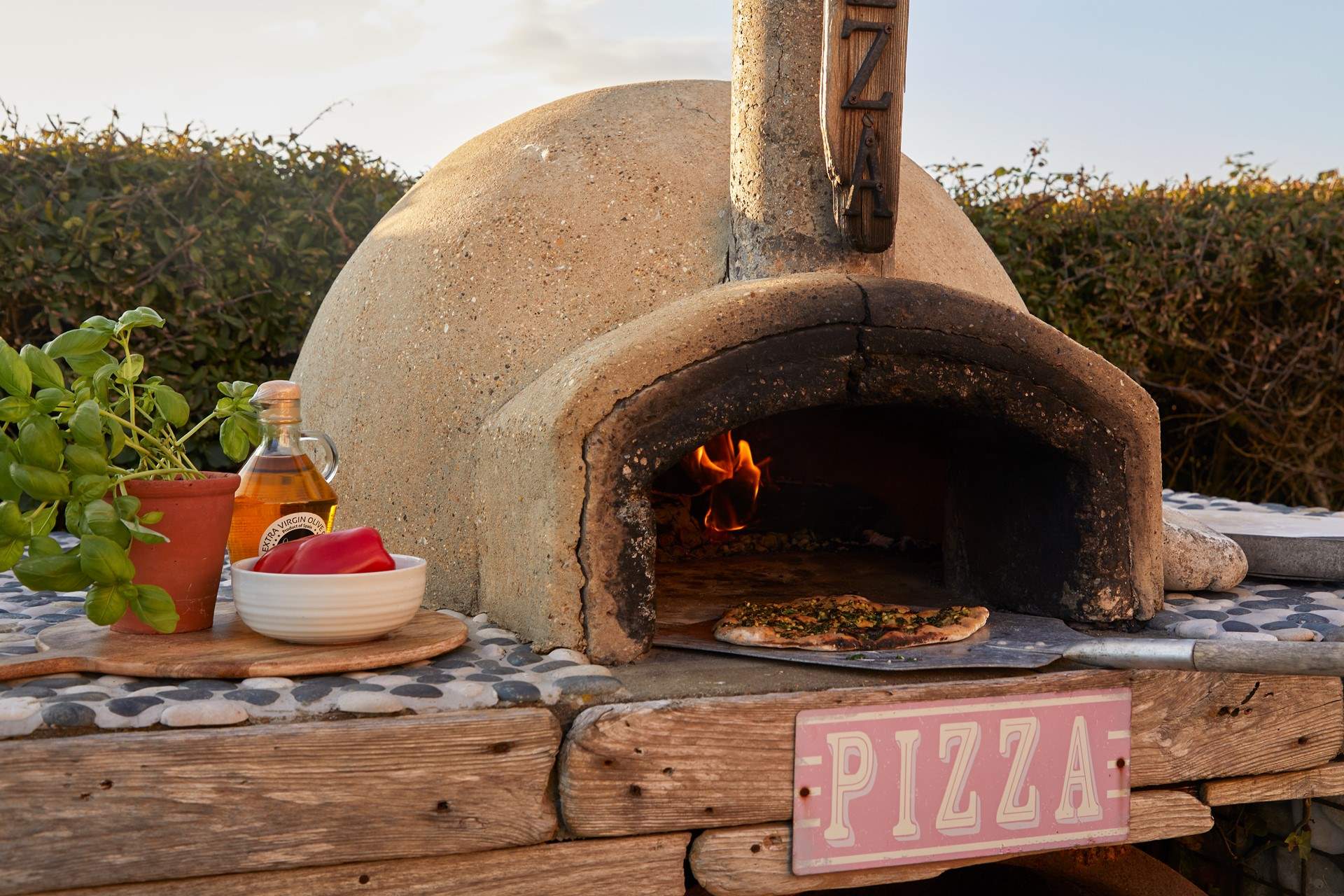 Try your hand at freshly made pizza, enjoyed sitting in the sunshine. 