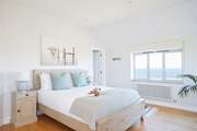 Bedroom 1 is beautifully furnished in pastel shades for a restful night.