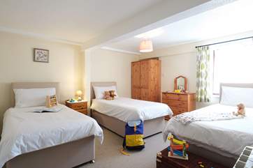 Three single divan beds in the ground floor bedroom.